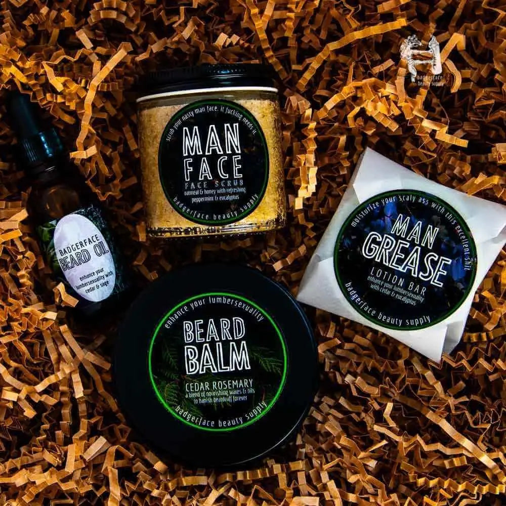 Beard Gift Set - Plasticology featuring beard oil, face scrub, beard balm, and lotion bar on shredded kraft paper background. Ideal for grooming and skincare.